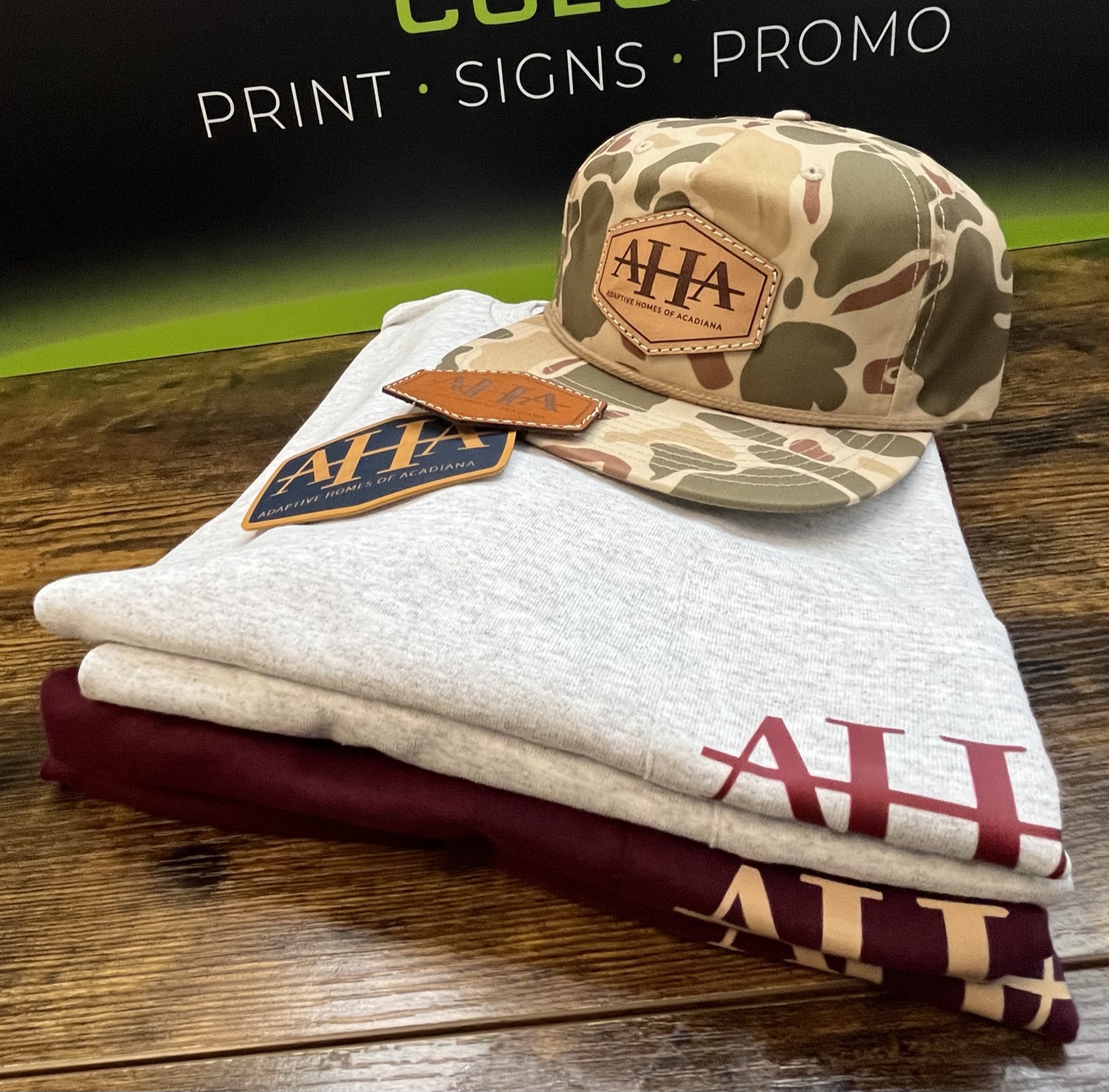 Branded polo shirts, tees and hats folded on a shelf