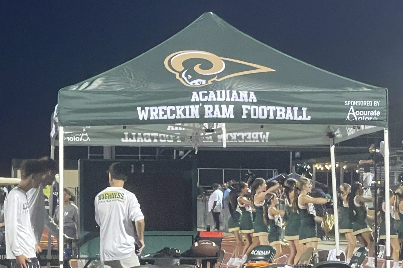 Acadiana Wreckin' Ram Football team tent on the sideline at a night game