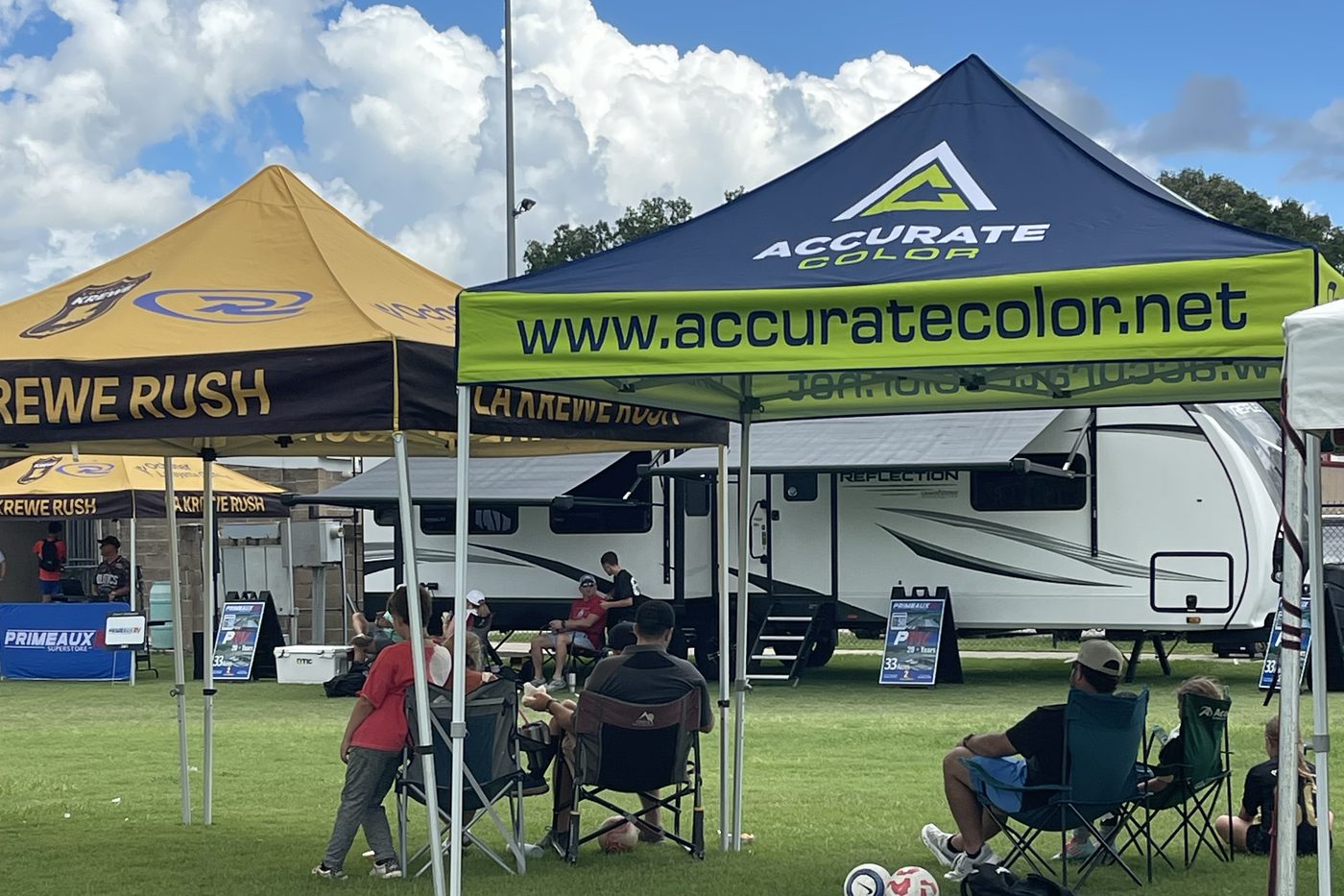 Accurate Color and LA Krewe Rush tents side by side at an outdoor tournament