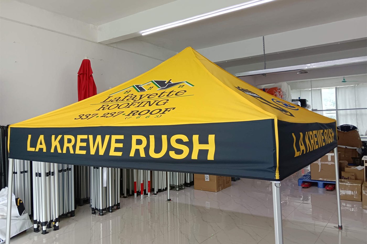 Lafayette Roofing and LA Krewe Rush yellow and black canopy tent