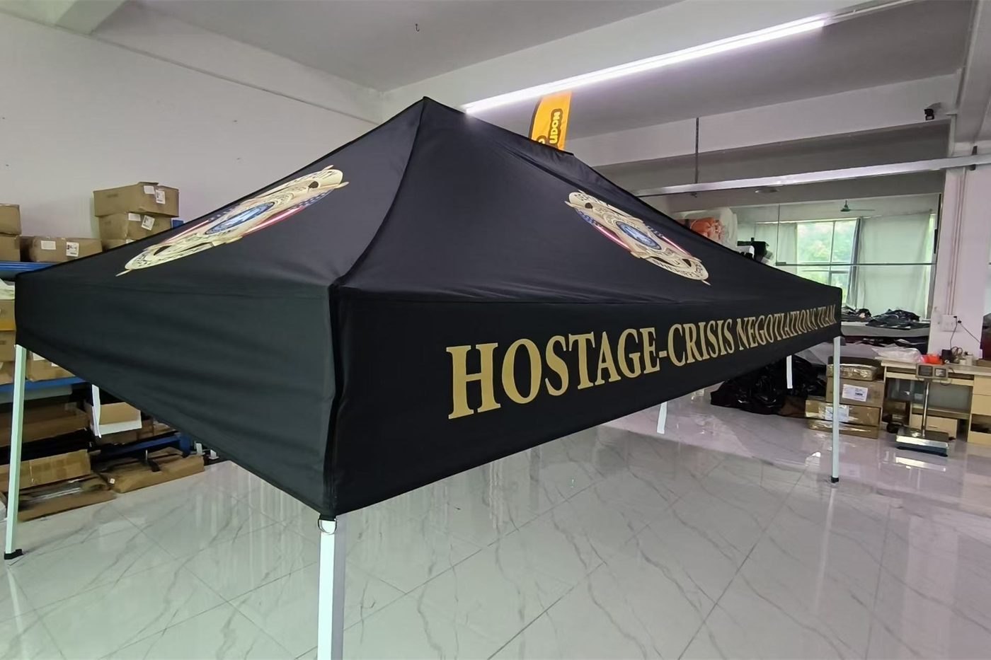 Black and gold canopy tent printed for a hostage-crisis negotiation team